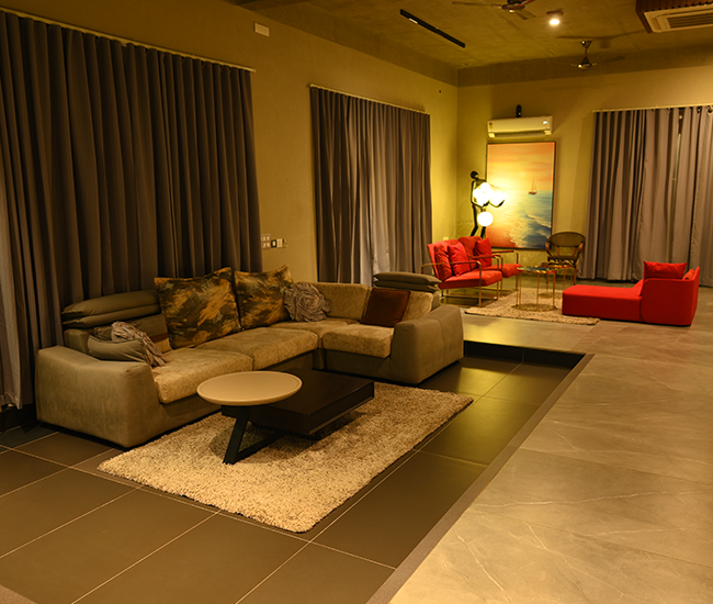 Elegant indoor seating area inside luxury villa stay at Kovalam, ECR Chennai.