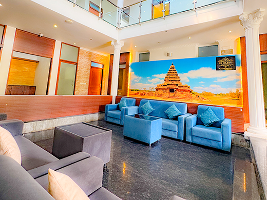 Comfortable sofa seating in Amrith Palace living area at ECR Chennai supports relaxed family stays