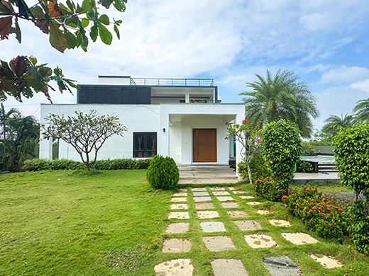 Green garden area at The Landmark Villa in ECR Chennai creates peaceful outdoor relaxation space