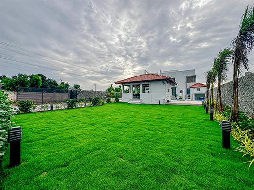Green garden space at Zephyr Villa in ECR Chennai creates a relaxing outdoor area for private stays