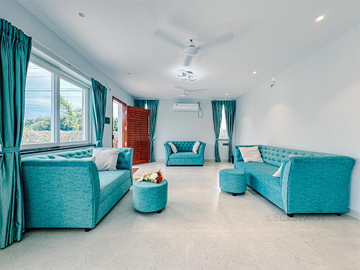 Comfortable sofa seating in Zephyr Villa living area at ECR Chennai supports relaxed family stays
